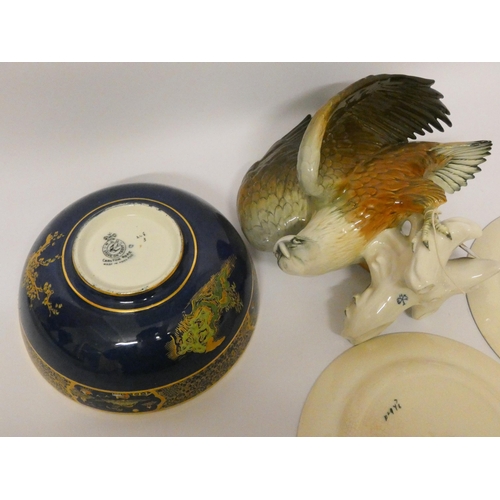 241 - A Carlton ware fruit bowl, two Doulton Dickens ware plates and a continental figure of an eagle