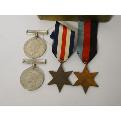 245 - Four World War II medals within a 1914 Christmas tin