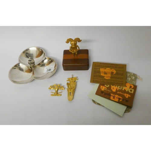 250 - A silver plated hor d'oeuvres dish and three pieces of Aztec inspired metal ware to include brooches... 