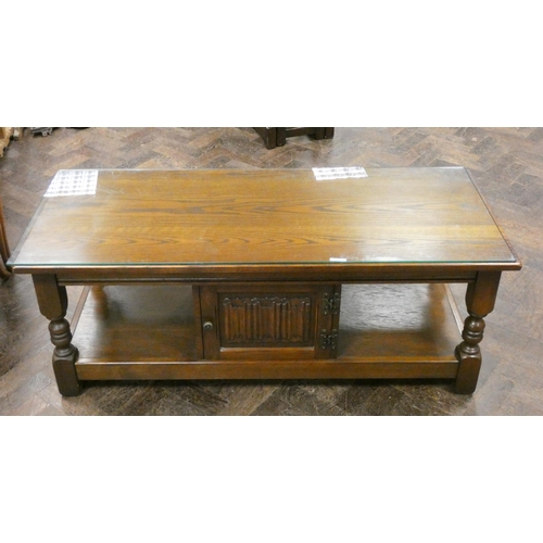 118 - A long reproduction oak double sided coffee table fitted cupboards with glass top