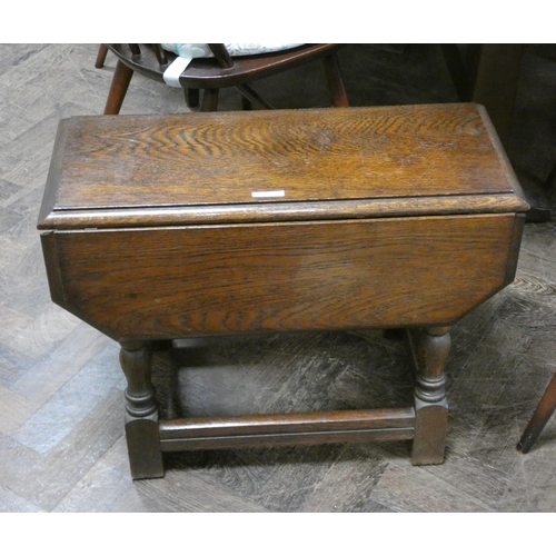 149 - A small reproduction oak drop leaf coffee table, the swivel top on turned legs, 2' wide