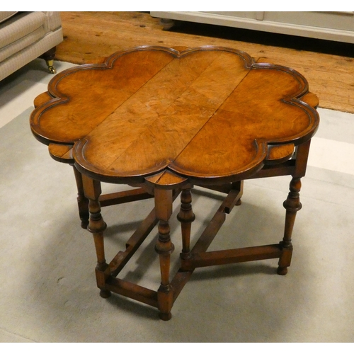 150 - A 1920's walnut occasional coffee table with drop leaves with a floral shaped top standing on turned... 