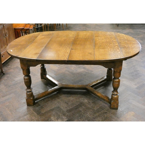 159 - Titchmarsh & Goodwin oval oak plank top dining table with centre leaf standing on bulbous legs with ... 