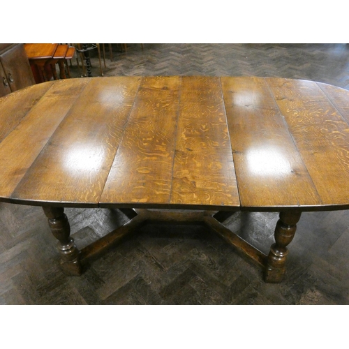 159 - Titchmarsh & Goodwin oval oak plank top dining table with centre leaf standing on bulbous legs with ... 