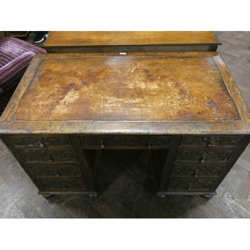 165 - A Victorian carved oak kneehole desk fitted nine drawers with inset brown leather top, 4' X 2'3