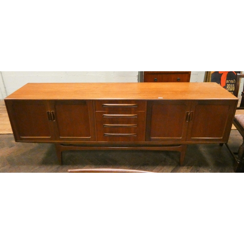 181 - A 1970's/80's long G Plan teak sideboard fitted four centre drawers and four cupboards, 7' long