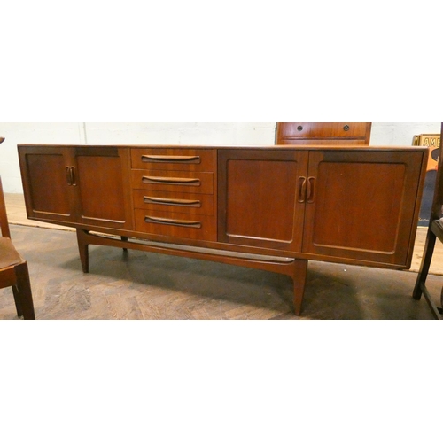 181 - A 1970's/80's long G Plan teak sideboard fitted four centre drawers and four cupboards, 7' long