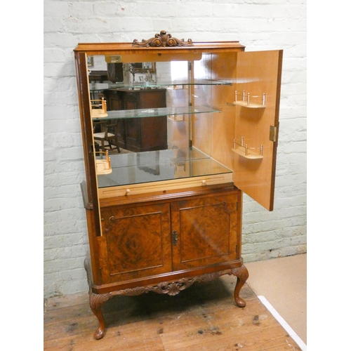 195 - A figured walnut four door cocktail cabinet with brass furniture standing on cabriole legs, 35