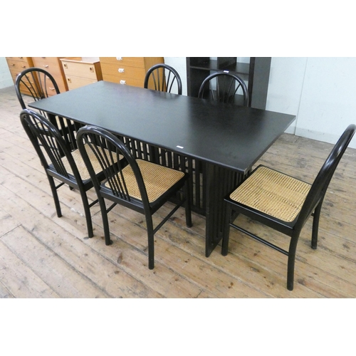 73 - A modern black ash dining table and six matching chairs with rush seats