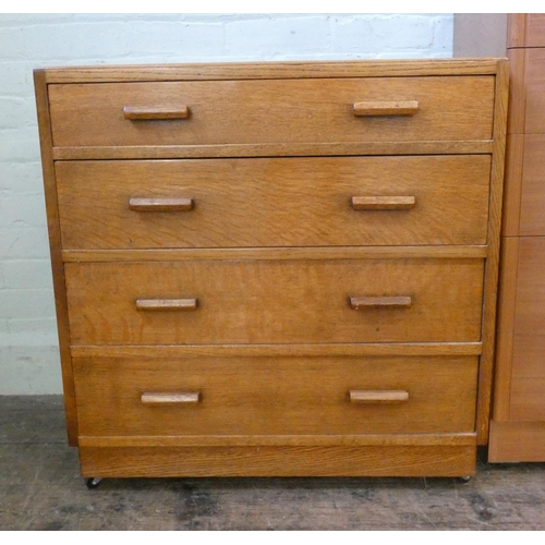 83 - A modern teak chest of five long drawers, 2'6 wide together with an oak chest of four drawers