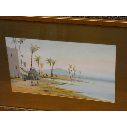 26 - A pair of gilt framed watercolours of Arabian desert scenes, signed J Moniti, image size 9