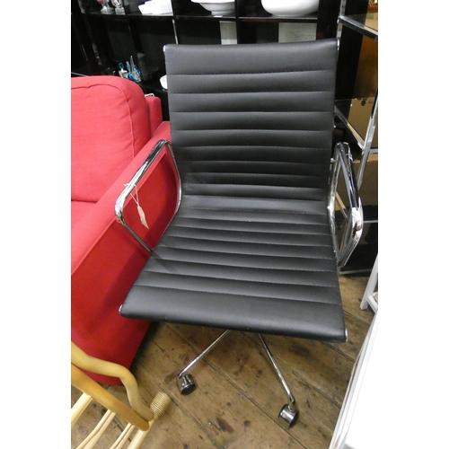 127 - A modern chrome framed and black leather revolving office elbow chair