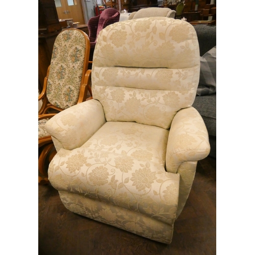 174 - A manual reclining easy chair in pale green and floral patterned covering