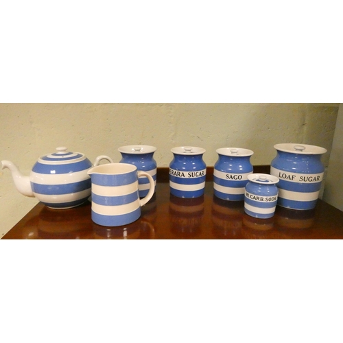 186 - Five Green and Company Cornish ware storage jars with lids, a teapot and a milk jug