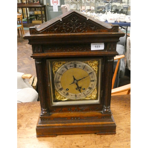 189 - An Edwardian walnut mantle or bracket clock with striking movement with brass and silver dial signed... 