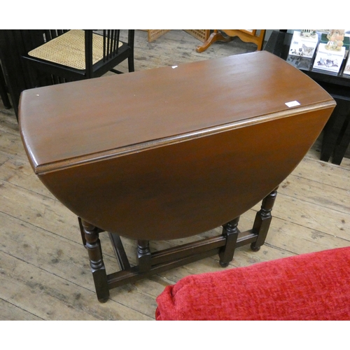 70 - A stained oak oval gate leg dining table on turned legs, 3' wide