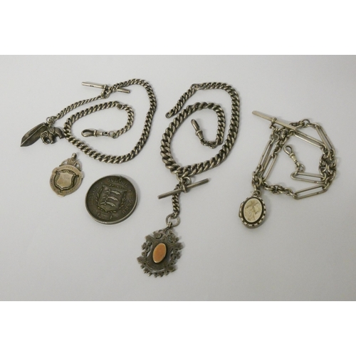 422 - Three late Victorian Edwardian watch Albert chains with medallions, fobs and charms, 161gms