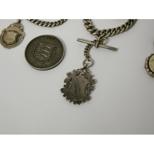 422 - Three late Victorian Edwardian watch Albert chains with medallions, fobs and charms, 161gms