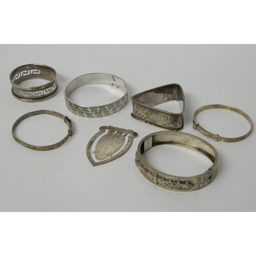 423 - A collection of silver bangles, napkin rings and an owl shaped bookmark, 80gms