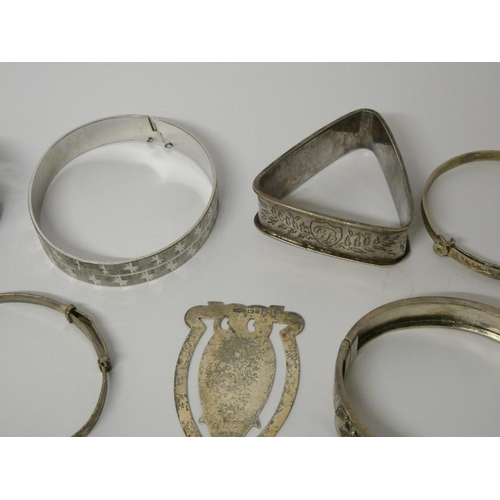 423 - A collection of silver bangles, napkin rings and an owl shaped bookmark, 80gms