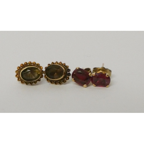 444 - A pair of 9ct gold brown topaz ear studs and a pair of red gem set ear studs.