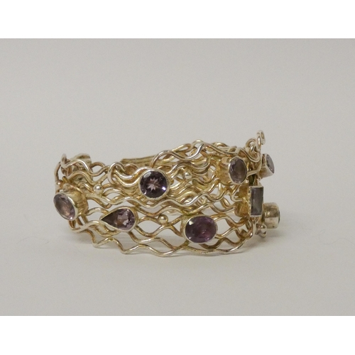 457 - A wide bespoke made silver and wirework amethyst set bangle. 31mm wide, gross weight 58 grams