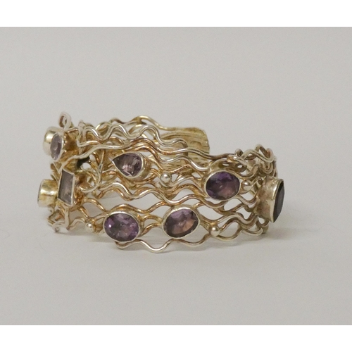 457 - A wide bespoke made silver and wirework amethyst set bangle. 31mm wide, gross weight 58 grams