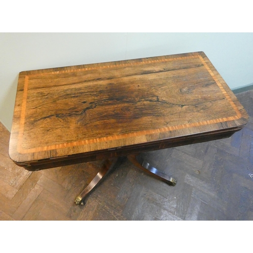 27 - Early 19th century rosewood inlaid fold over top card table on down swept pillar base, red baize lin... 