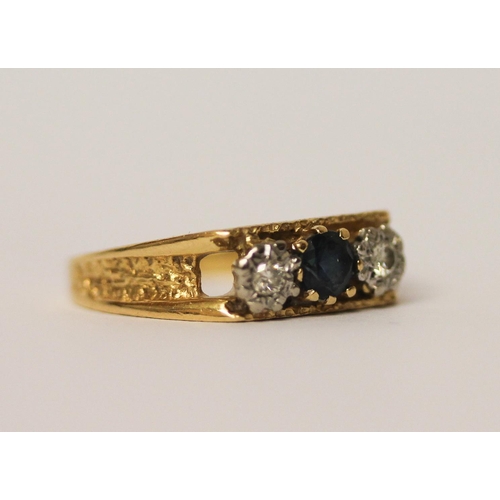 411 - 18ct gold three stone sapphire and diamond ring. Hallmarked, ring size O, 3.6 grams