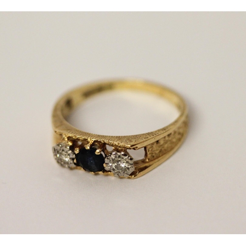 411 - 18ct gold three stone sapphire and diamond ring. Hallmarked, ring size O, 3.6 grams