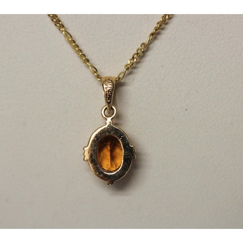 426 - Citrine oval pendant in 14ct yellow gold mount on an 18ct gold fine neck chain, gross weight 3.5gms