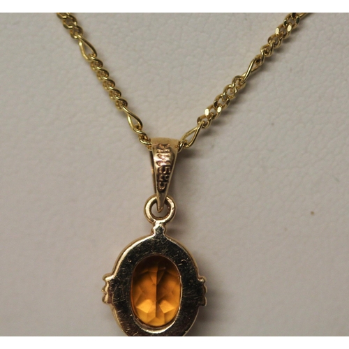 426 - Citrine oval pendant in 14ct yellow gold mount on an 18ct gold fine neck chain, gross weight 3.5gms