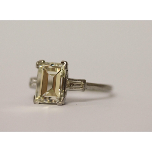 450 - An Art Deco solitaire diamond ring, the emerald cut diamond weighing approximately 3 carats, claw se... 