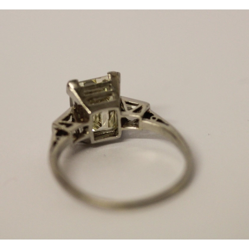 450 - An Art Deco solitaire diamond ring, the emerald cut diamond weighing approximately 3 carats, claw se... 