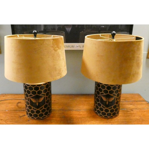 152 - A pair of painted Toleware bee and honeycomb painted black and gilt table lamps, with gold velvet sh... 