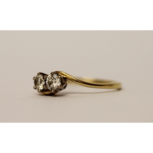 387 - A diamond two stone cross over design ring, on 18ct yellow gold band, hallmarked, ring size N, weigh... 