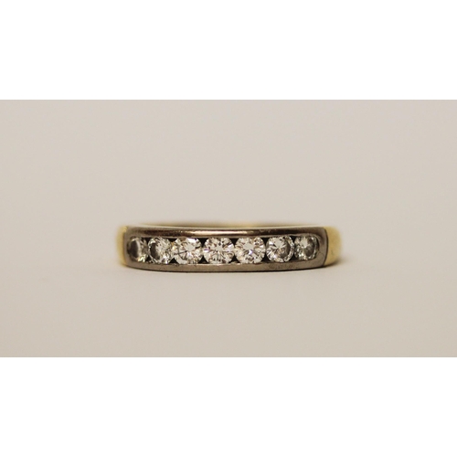 388 - A diamond half hoop eternity ring, channel set with seven brilliant cut diamonds, in 18ct yellow gol... 