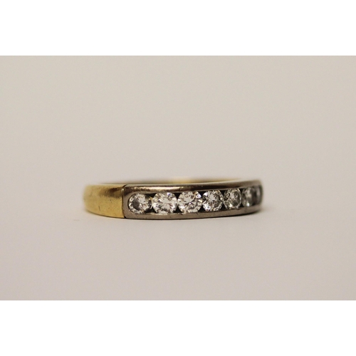 388 - A diamond half hoop eternity ring, channel set with seven brilliant cut diamonds, in 18ct yellow gol... 