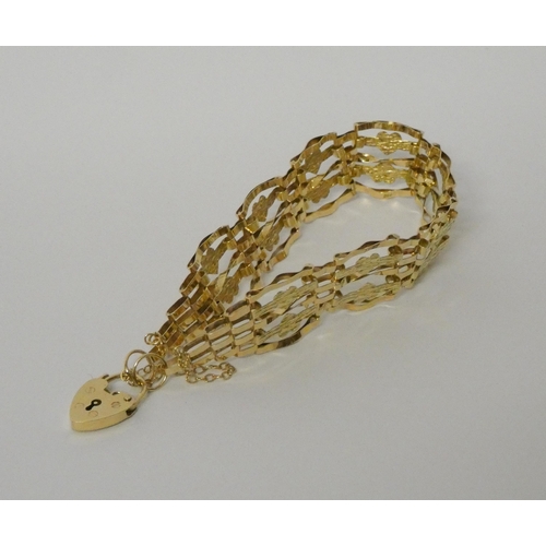 396 - 9ct yellow gold fancy link gate bracelet with heart shaped padlock fastening, Gross weight 8.2g