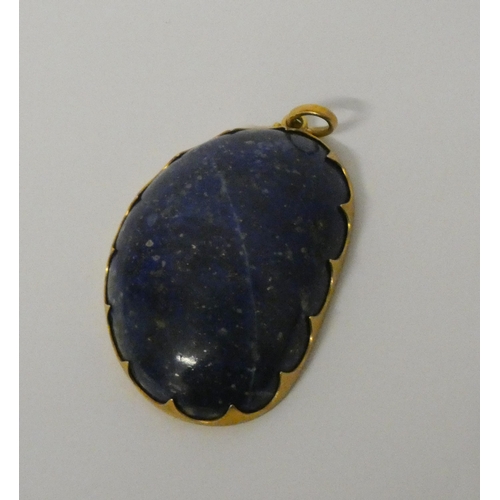 418 - Buccellati - a large lapis set zodiac pendant, circa 1970,  the 18ct gold open work and engraved mou... 