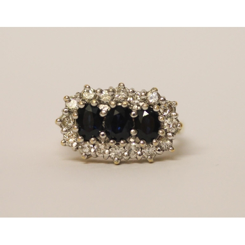 436 - A large  three stone sapphire and diamond cluster ring, on hallmarked 18ct yellow gold band, ring si... 