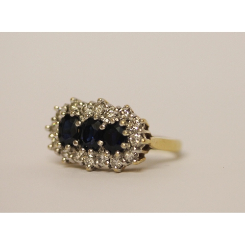 436 - A large  three stone sapphire and diamond cluster ring, on hallmarked 18ct yellow gold band, ring si... 