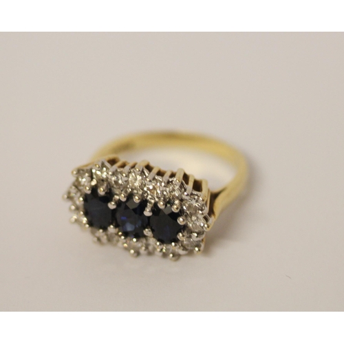 436 - A large  three stone sapphire and diamond cluster ring, on hallmarked 18ct yellow gold band, ring si... 