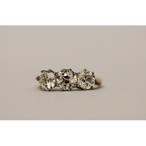 452 - A three stone diamond ring, set with old brilliant cut diamonds, with probate valuation dated 2022 s... 