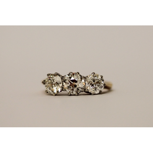 452 - A three stone diamond ring, set with old brilliant cut diamonds, with probate valuation dated 2022 s... 