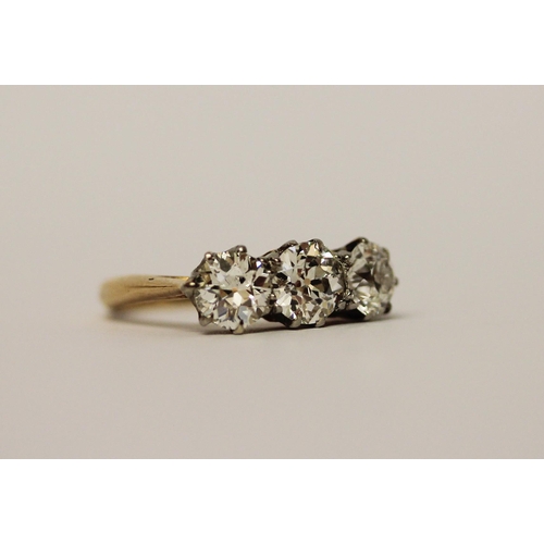 452 - A three stone diamond ring, set with old brilliant cut diamonds, with probate valuation dated 2022 s... 