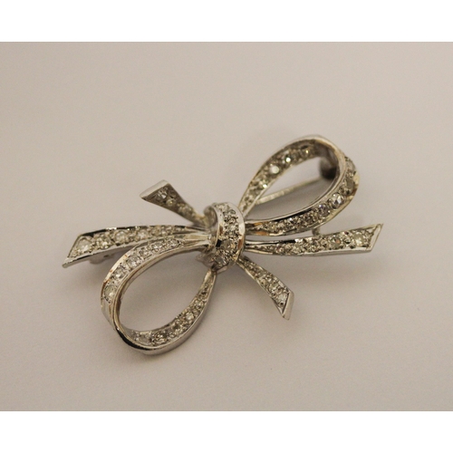 453 - A diamond ribbon bow brooch, set in 18ct white gold, 36mm across, weight 5g, in fitted box