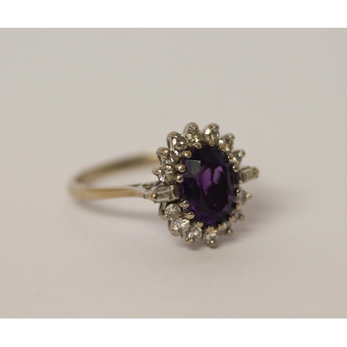 470 - An art deco style amethyst and diamond oval cluster ring, on 18ct white gold shank, marked 18. Ring ... 