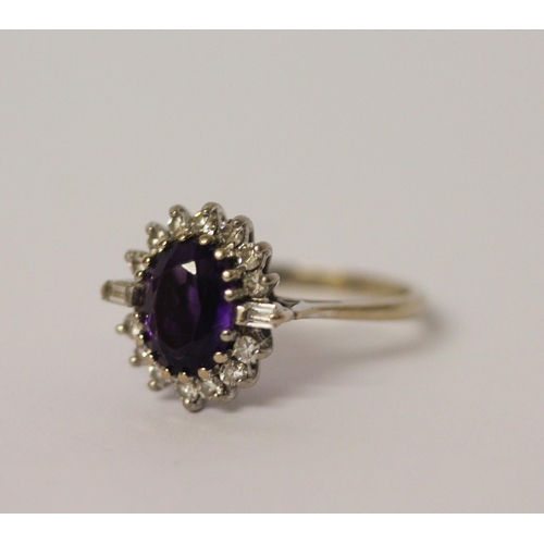 470 - An art deco style amethyst and diamond oval cluster ring, on 18ct white gold shank, marked 18. Ring ... 