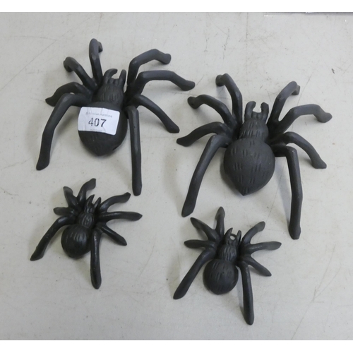 324 - Four cast iron various sized spiders